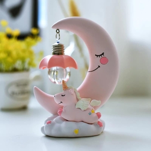 Lampada LED con luna e unicorno per ragazze rosa su un tavolo