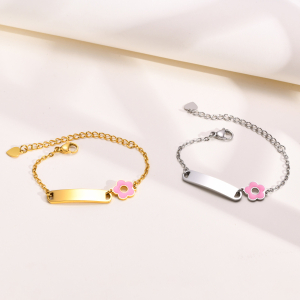 Due braccialetti d'oro e d'argento con un dettaglio di fiori rosa